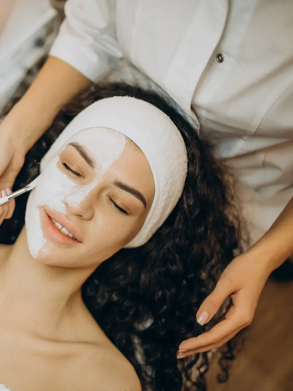 A client relaxing during a facial treatment at Elite Beauty Medi Spa